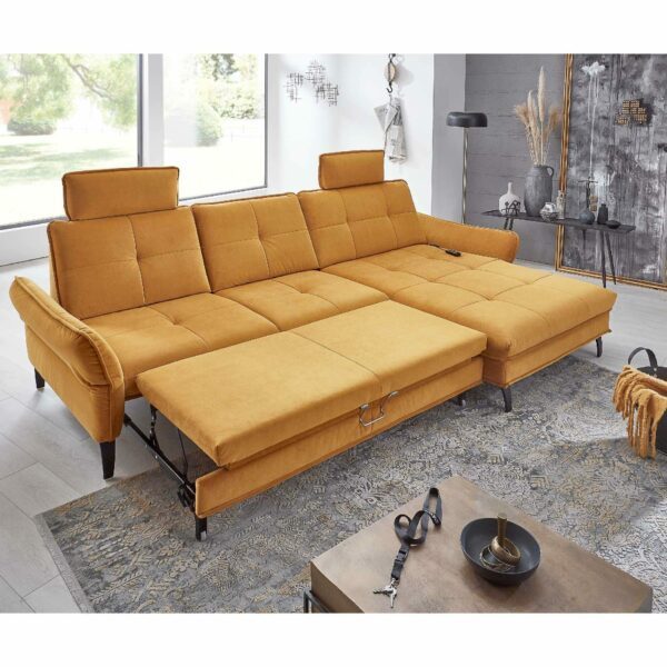 Couchliebe Key West Sofa mit Bezug in Curry und Ottomane rechts zeigt Bettfunktion als Wohnbeispiel